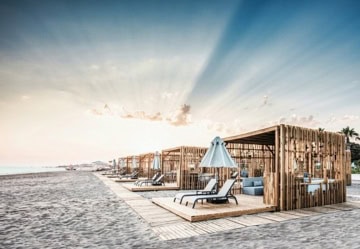 kleine Wind und Sonnenschutz Buden am Strand mit Veranda und Sonnenliegen